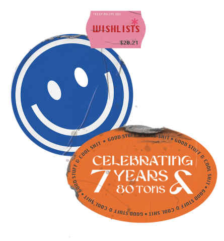 three overlapping stickers, one pink that says 'wishlists', one blue smiley face, and one orange that reads 'celebrating 7 years & 80 tons' 